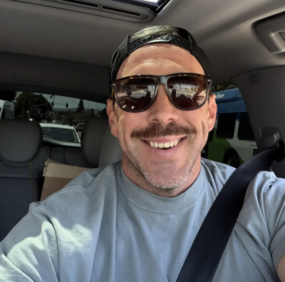Community member smiling in a car